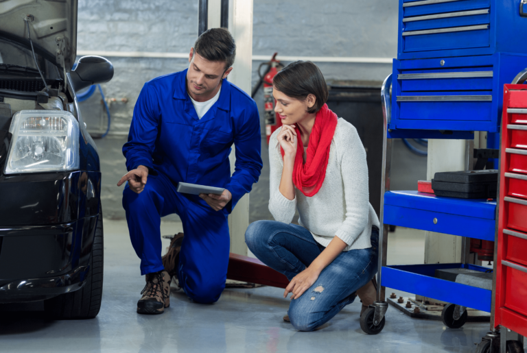 Car Technician explaining lady customer