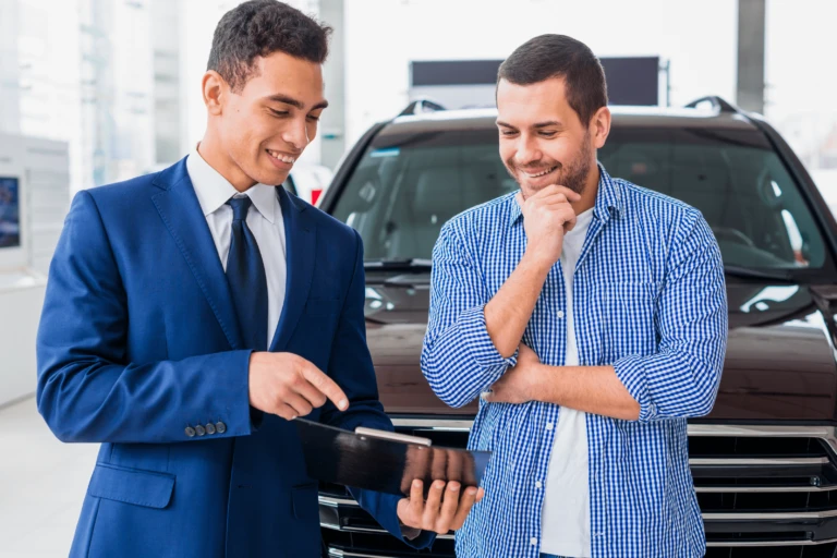Car dealer explaining customer