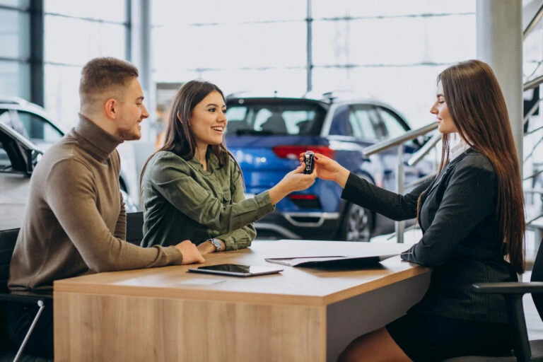 Car dealer discussing with customer